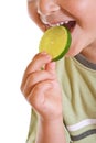 Closeup of kid with a slice of lime Royalty Free Stock Photo