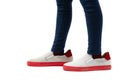 Closeup of kid wearing adult shoes on white background. Concept of maturity and growing up