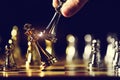 Closeup king chess piece defeated enemy or trade competitor by checkmate at end of chessboard game. Businessman moving chess to Royalty Free Stock Photo