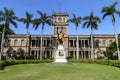 Closeup of King Kamehameha statue in downtown Honolulu, with Iolani palace background