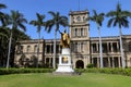 Closeup of King Kamehameha statue in downtown Honolulu, with Iolani palace background