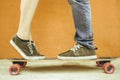 Closeup kissing couple at skateboard and red wall background Royalty Free Stock Photo