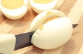 Kitchen knife cutting cooked egg on board Royalty Free Stock Photo