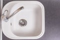 Closeup of Kitchen Marble Sink and Installed New Faucet. Indoors Royalty Free Stock Photo