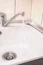 Closeup of Kitchen Marble Sink and Installed New Faucet. Indoors Royalty Free Stock Photo