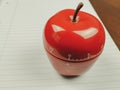 Closeup of kitchen timer in apple shape as a pomodoro study technique for schools for timing study sessions and beating