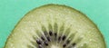 Closeup of a kiwi fruit on a green background Royalty Free Stock Photo