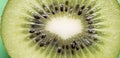 Closeup of a kiwi fruit on a green background Royalty Free Stock Photo