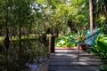 Closeup of a knitted chair on a wooden dock on a lake surrounded by vegetation Royalty Free Stock Photo