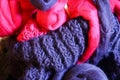 Closeup of knitted colorful purple pink blanket, ball of merino wool, knitting needles Royalty Free Stock Photo