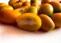 Closeup of a kumquat fruit half sliced isolated on white background Royalty Free Stock Photo