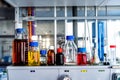 Closeup of laboratory glassware filled with various colored liquids