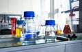 Closeup of laboratory glassware filled with various colored liquids