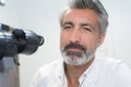 Closeup laboratory worker next to microscope eyepiece