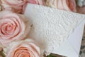 closeup of lacy white envelope on roses bed Royalty Free Stock Photo