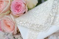 closeup of lacy white envelope on roses bed Royalty Free Stock Photo