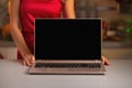 Closeup on laptop blank screen showing by woman in kitchen