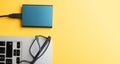 Closeup of a laptop edge with glasses on it and a charger Royalty Free Stock Photo