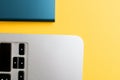 Closeup of a laptop edge and a hard drive on yellow background Royalty Free Stock Photo