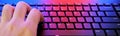 Closeup of laptop keyboard illumination with a red and blue light on it. Royalty Free Stock Photo