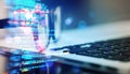 Closeup of laptop keyboard with overlay of programming code and blurred background Royalty Free Stock Photo