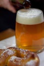 Closeup of a large glass mug of beer and a soft pretzel Royalty Free Stock Photo