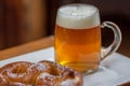 Glass mug of beer and pretzel