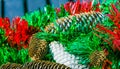 Large pine cones with red and green Christmas tinsel Royalty Free Stock Photo