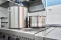 Closeup of large pots on the stove. Chef cooking at commercial kitchen - hot job. real dirty restaurant kitchen. Royalty Free Stock Photo