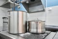 Closeup of large pots on the stove. Chef cooking at commercial kitchen - hot job. real dirty restaurant kitchen. Royalty Free Stock Photo