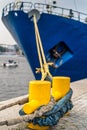Closeup of a large ship anchored to a steel dock anchor with thick rope Royalty Free Stock Photo
