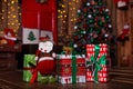 Closeup of a large stack of wrapped Christmas presents of varying sizes and shapes in Xmas interior. Royalty Free Stock Photo