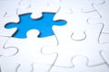 the last piece of jigsaw puzzle missing on blue background to complete the mission Royalty Free Stock Photo