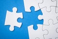 The last piece of jigsaw puzzle missing on blue background to complete the mission Royalty Free Stock Photo