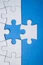 the last piece of jigsaw puzzle missing on blue background to complete the mission Royalty Free Stock Photo