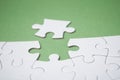 The last piece of jigsaw puzzle missing on green background to complete the mission Royalty Free Stock Photo