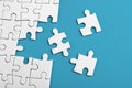 Closeup of the last piece of puzzle missing on blue background Royalty Free Stock Photo