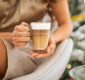 Closeup on latte macchiato in hand of woman Royalty Free Stock Photo