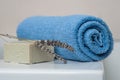 Lavender soap and rolled blue towel in the bathroom Royalty Free Stock Photo