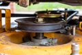 Closeup of lawn mower deck, drive belt, pulley and blade spindle.