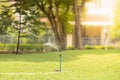 Closeup of lawn sprinkler watering garden green grass under sunlight Royalty Free Stock Photo