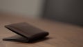 closeup leather wallet on wood table