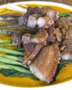 Closeup of Lechon Kawali na Kare Kare or Crispy Pork in Peanut Sauce. A Filipino fusion dish