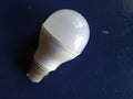 Closeup of LED Light Bulb isolated on Blue Background. LED Bulb holding in hand Royalty Free Stock Photo