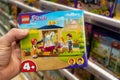 Closeup of Lego box in hand of buyer in a toy store supermarket. Minsk, Belarus, 2023