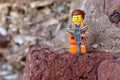 Closeup of a Lego minifigure construction worker on a rock
