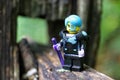 Closeup of a Lego minifigure of the Cyborg superhero on a wooden surface