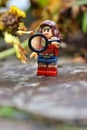 Closeup Lego minifigure of the Wonder Woman on a rocky surfac