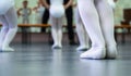 Closeup legs of little ballerinas group in white shoes practicing in classical ballet studio Royalty Free Stock Photo