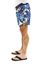 Closeup on legs of male in shorts and flip flops Royalty Free Stock Photo
